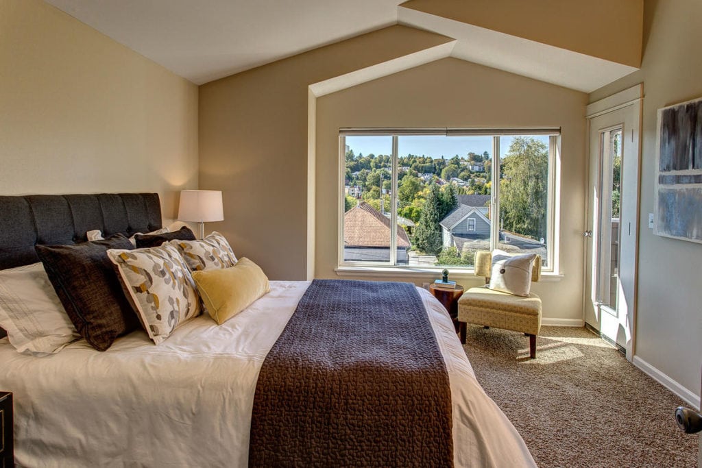 Master bedroom with vaulted ceilings, views, private balcony & ensuite bathroom.