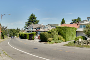 Residential street in Magnolia neighborhood of Seattle, Washington. Houses are set back from street and have mature landscaping.