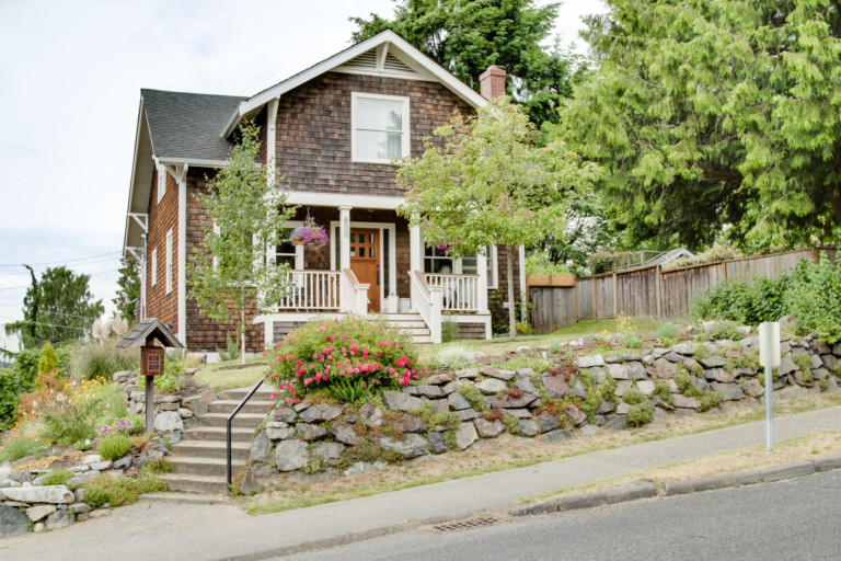 Craftsman style home in the Maple Leaf neighborhood of Seattle. House has mature landscape on terraced yard.