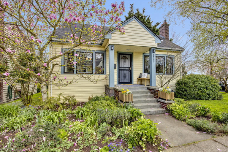 Single family cottage style home in Ballard/Sunset Hill neighborhood of Seattle, Washington. House has mature landscape on level yard.