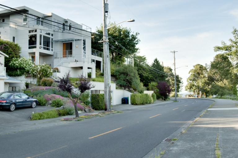 Multi-level condominium in Leschi neighborhood of Seattle, Washington. House has stark landscape on terraced yard.