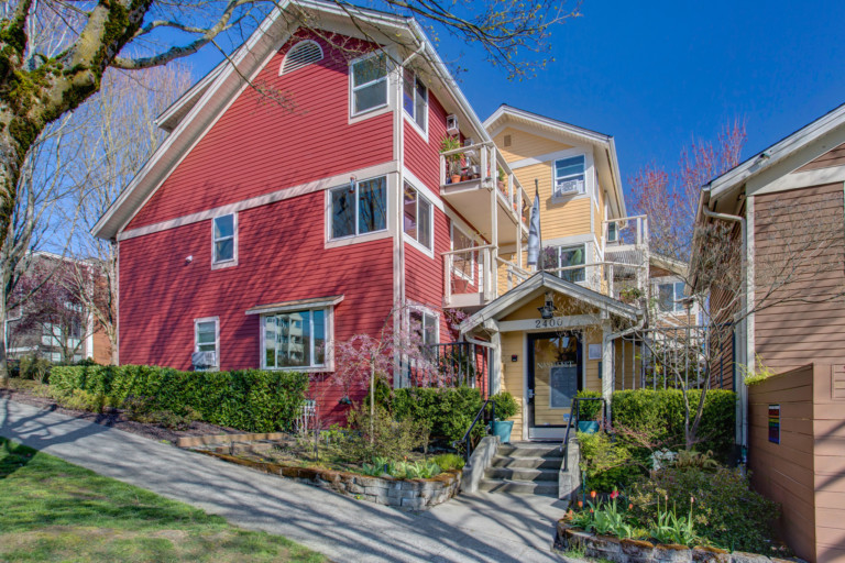 Multi-level condominium in Madison Valley Park neighborhood of Seattle, Washington. House has mature landscape on terraced yard.