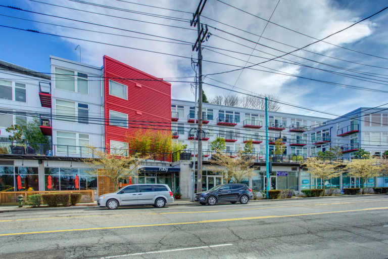 Four-story condominium complex with retail and mixed use on the ground floor. Located in the Eastlake neighborhood of Seattle, Washington. On-street parking.