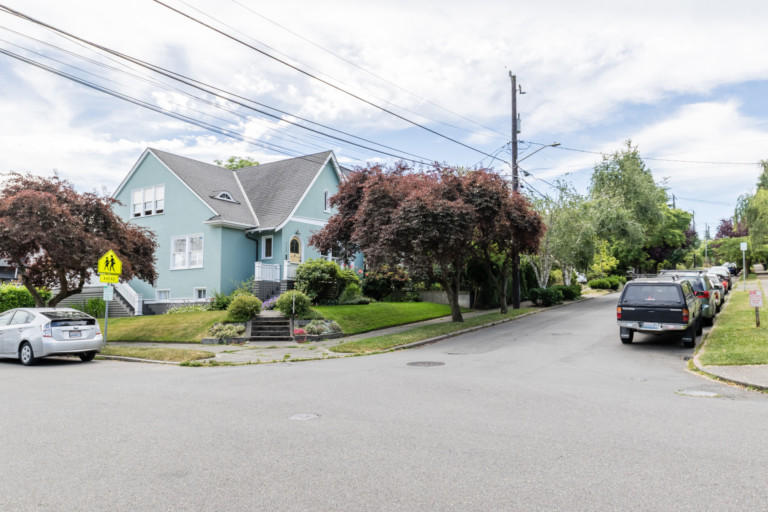 Single family home in Portage Bay Roanoke neighborhood of Seattle, Washington. House has mature landscape on terraced yard.