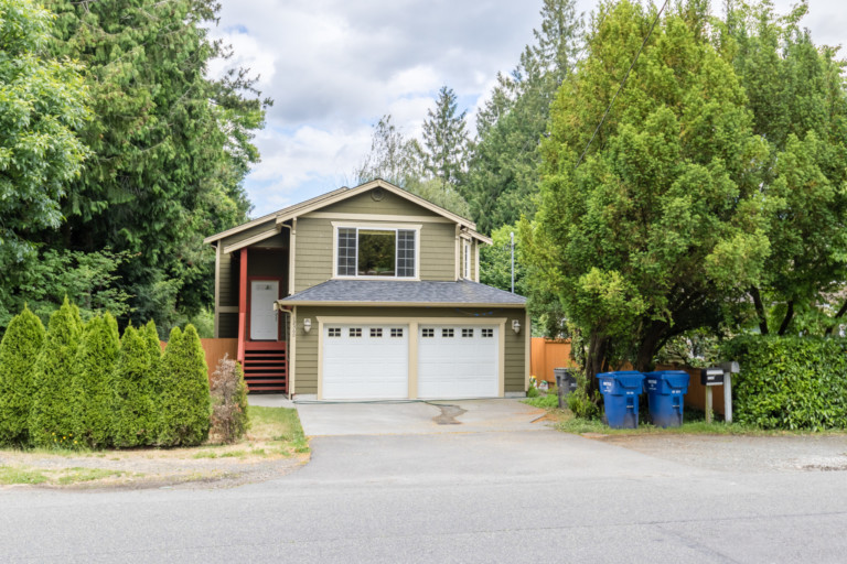 Single family two-story Northwest style home in Pinehurst neighborhood of Seattle, Washington. House has mature landscape on level yard.