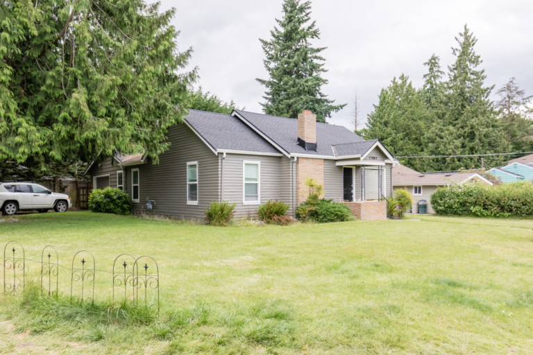 Single family cottage style home in Pinehurst neighborhood of Seattle, Washington . House has mature landscape on level yard.