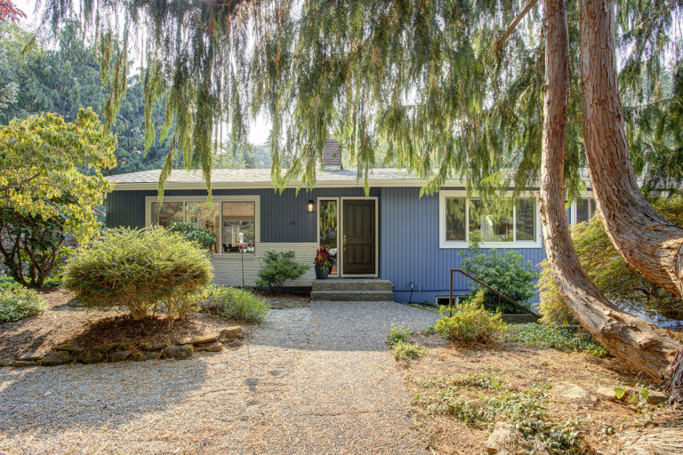 Single family split-level house in Kenmore-Lake Forest Park neighborhood of Seattle, Washington. House has mature landscape on level yard.