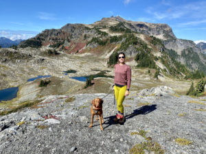 Team Diva Real Estate - Seattle - National Hiking Day - photo of woman hiking along trail with dog
