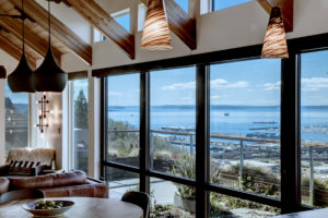 Modern Queen Anne view home with open living area Nano doors rooftop deck and view out to Interbay and Puget Sound and Olympic Mountains