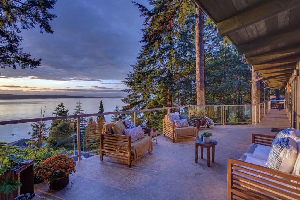 Puget Sound view from mid-century home at sunset on exterior deck with view of Vashon Island