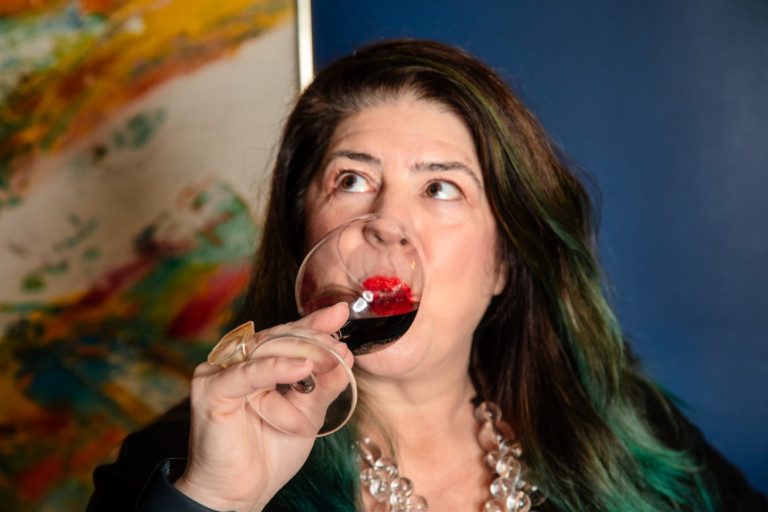 Photo of Diva Kim enjoying a glass of Pinot Noire wine
