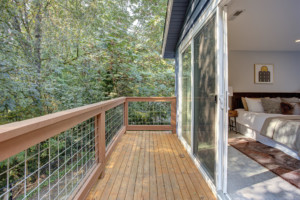 Kenmore Mid Century Home Back deck from the primary suite wiht a wall of windows