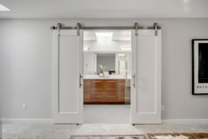Kenmore Mid Century Home Barn doors entrance to the primary suite bathroom
