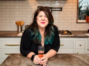 kim leaning on a countertop with rosé