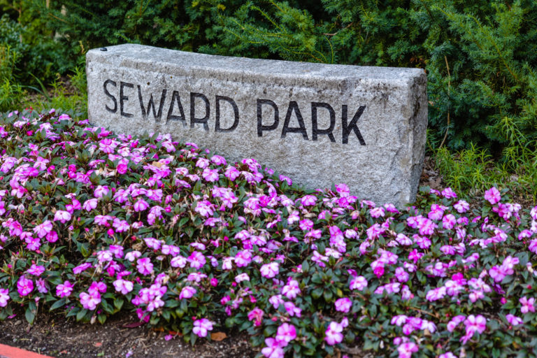 Southeast Seattle, Seward Park engraved into stone with flowers surrounding it