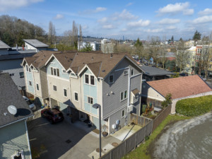 Drone of you of exterior of side building of a Columbia City townhouse showing townhouse and surrounding buildings.
