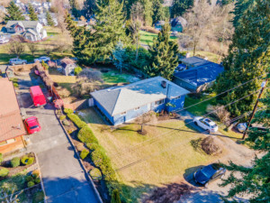 Drone view of Home in Bothell showing house, driveway, yard and neighbors.