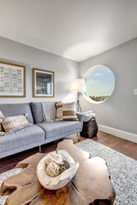 Living room couch and large porthole style window