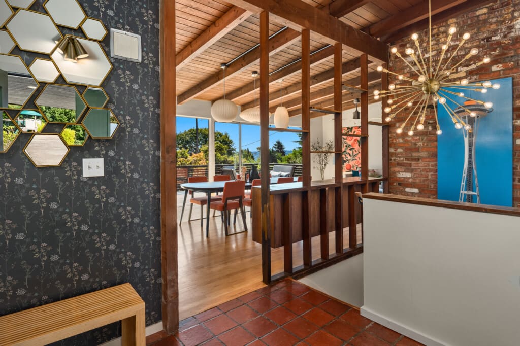 Vaulted wood ceilings and custom light fixture in the entryway of this custom built mid-century modern home in South Seattle