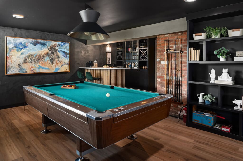 Renovated basement billiard room with a built-in bar in this custom built mid-century modern home.