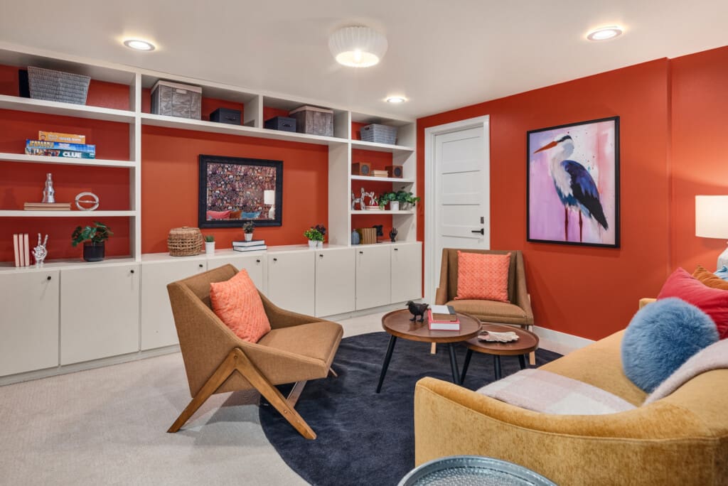 Cozy basement media room with plush carpet and built-in cabinets in this custom built and renovated mid-century modern home in South Seattle.