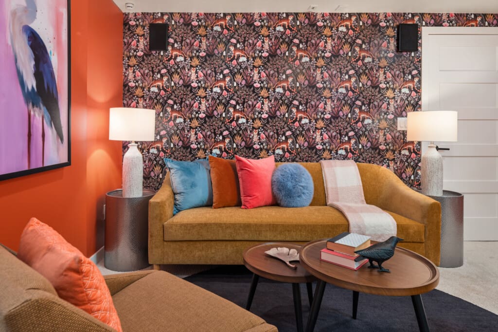 Updated modern basement in this custom built mid-century modern home with wall paper and built-ins