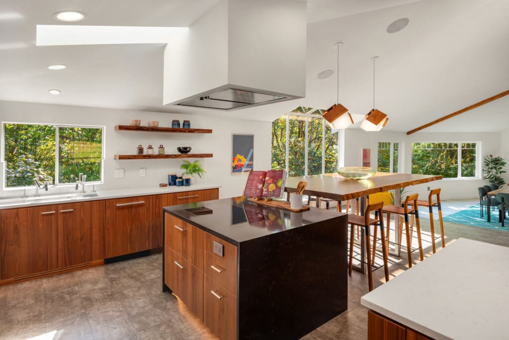 Custom Space Theory black walnut veneer cabinets and hidden fridge in a remodeled Redmond kitchen