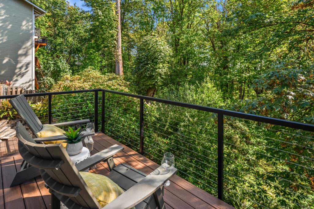 Wooded backyard and massive deck of a renovated home in Redmond WA